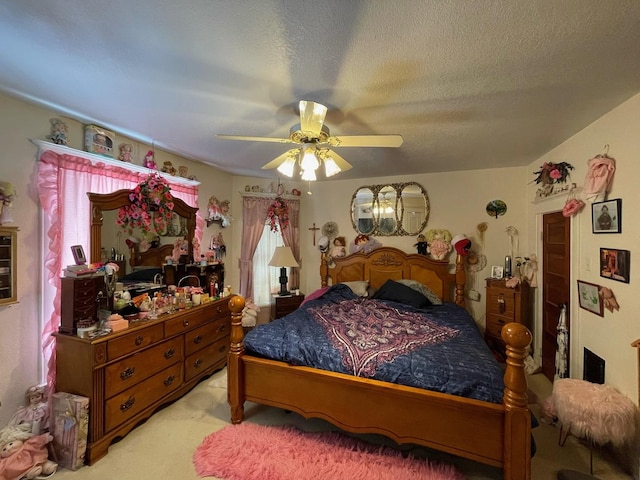 bedroom featuring ceiling fan, light colored carpet, and a textured ceiling