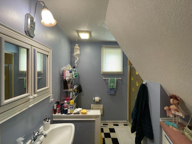 bathroom featuring sink and a textured ceiling