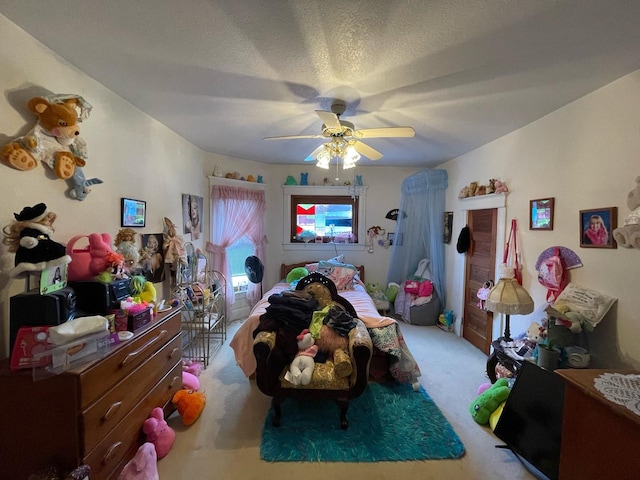 carpeted bedroom featuring a textured ceiling and ceiling fan