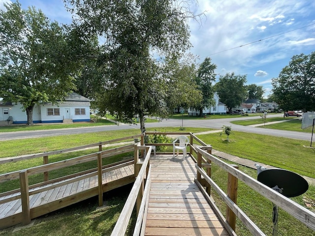 view of dock featuring a lawn