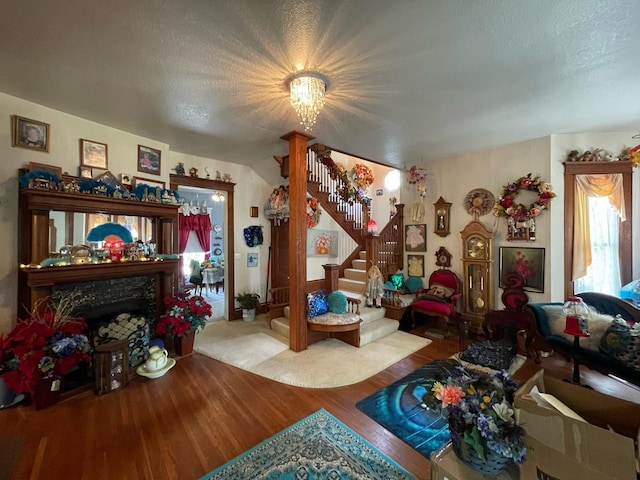 interior space with hardwood / wood-style flooring, a high end fireplace, a chandelier, and a textured ceiling