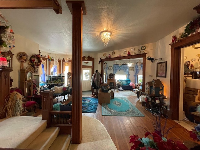 living room featuring light hardwood / wood-style floors and a textured ceiling