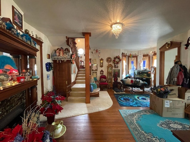 interior space featuring a notable chandelier, hardwood / wood-style flooring, and a textured ceiling