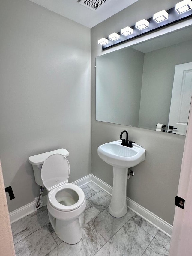 bathroom featuring toilet and tile patterned floors