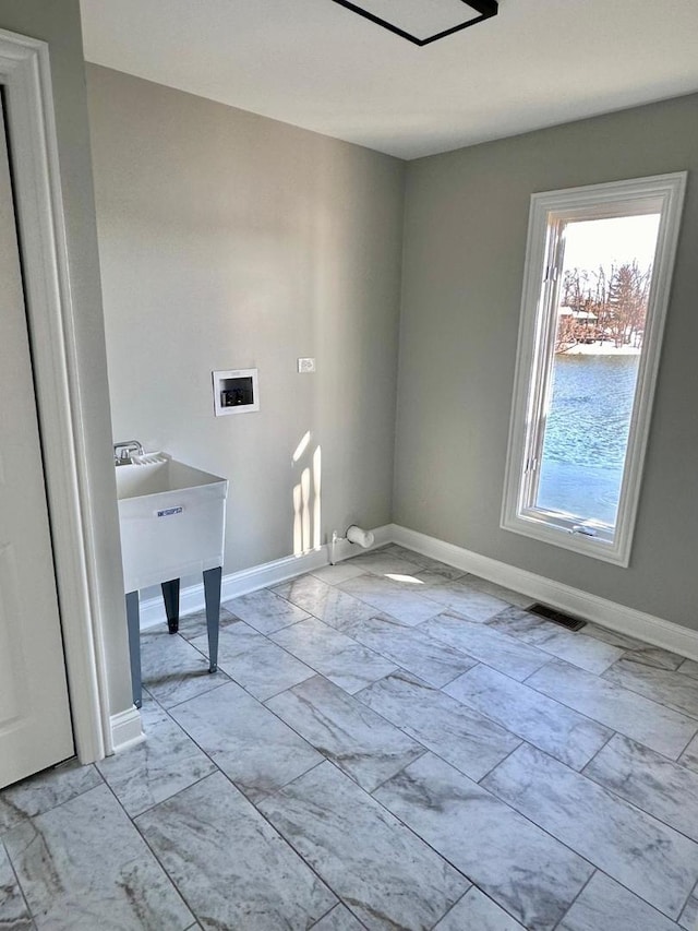 washroom with light tile patterned floors and washer hookup