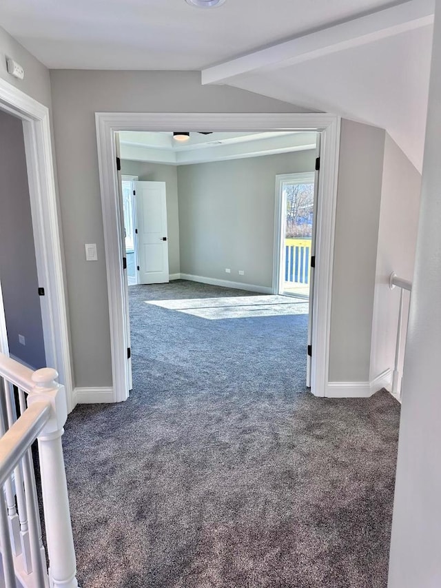 hall featuring carpet flooring and lofted ceiling with beams