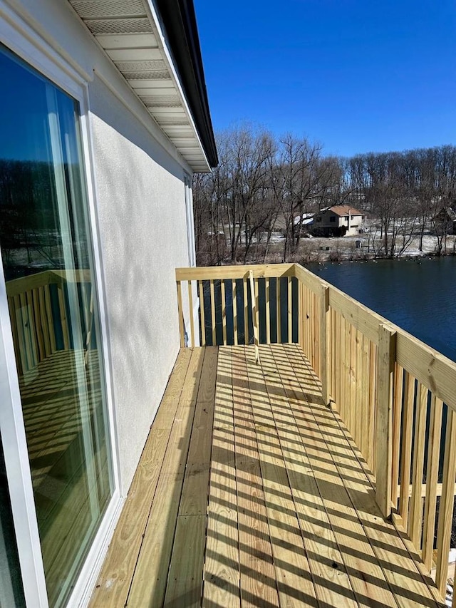 wooden terrace featuring a water view