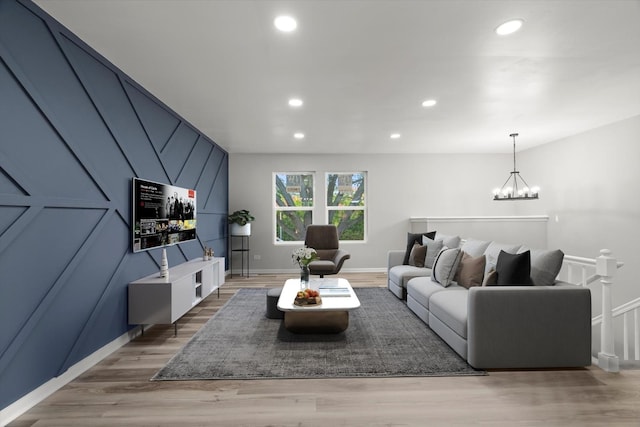 living room featuring a chandelier, recessed lighting, and light wood-type flooring