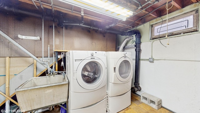 washroom with washing machine and dryer and sink