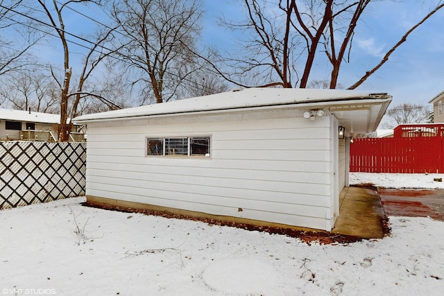 view of snow covered exterior featuring an outbuilding