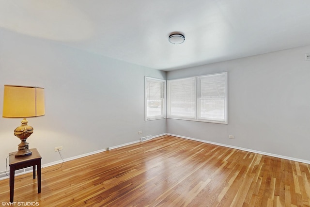 unfurnished room featuring hardwood / wood-style floors