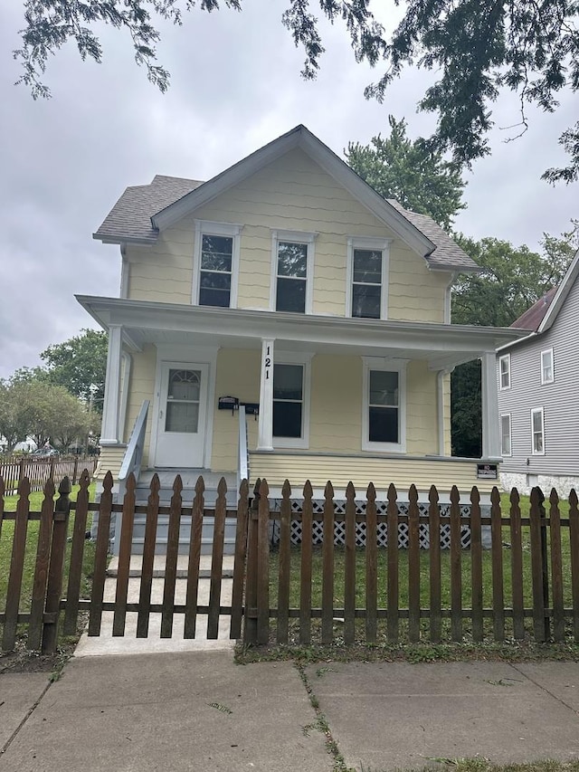 view of front of home with a porch and a fenced front yard