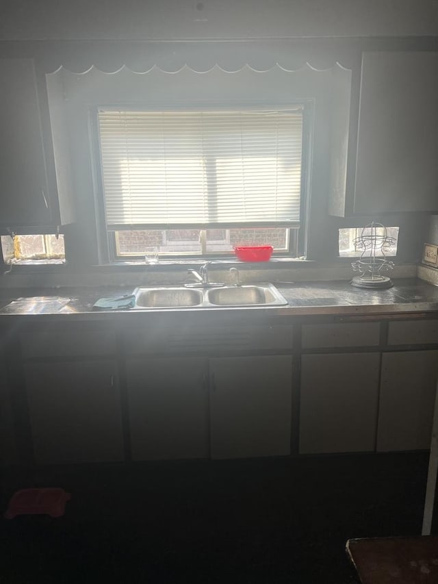 kitchen with white cabinetry and a sink