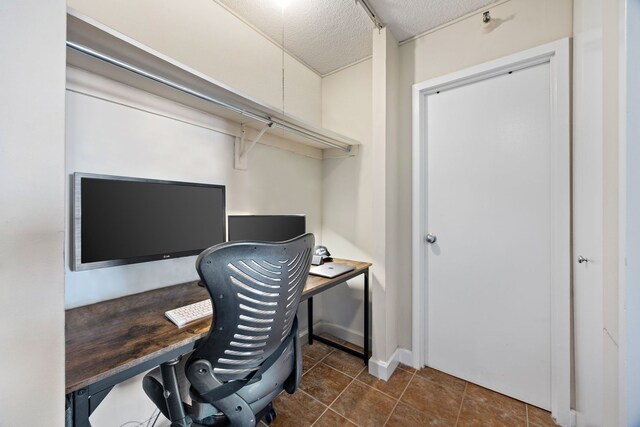 office space with dark tile patterned floors and a textured ceiling