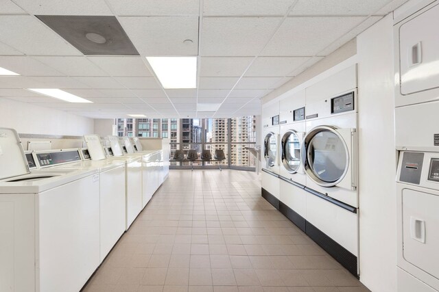 laundry area featuring light tile patterned floors, stacked washer and clothes dryer, and separate washer and dryer