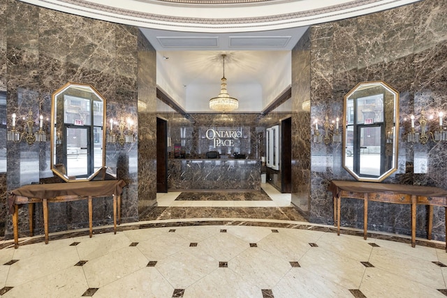 tiled entrance foyer featuring tile walls and crown molding