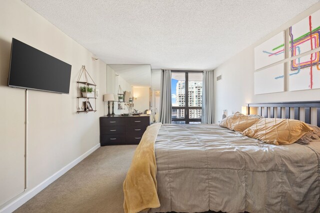 carpeted bedroom featuring a textured ceiling