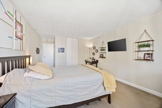 bedroom featuring a textured ceiling and carpet