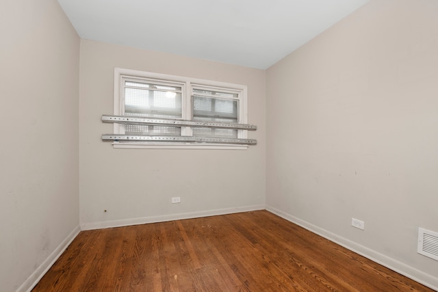 unfurnished room with wood-type flooring