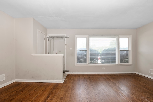 spare room with dark wood-type flooring