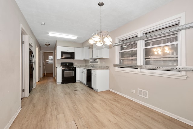 kitchen featuring decorative light fixtures, black appliances, a chandelier, white cabinetry, and light wood-type flooring