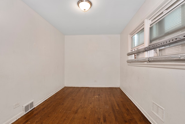 empty room with dark hardwood / wood-style floors