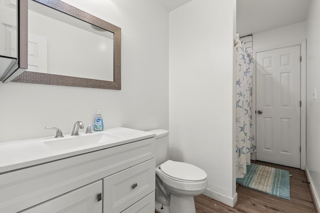 bathroom featuring vanity, toilet, and hardwood / wood-style floors