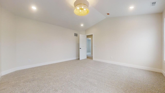 unfurnished room featuring carpet and lofted ceiling