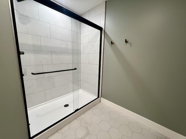 bathroom featuring tile patterned floors and a shower with shower door