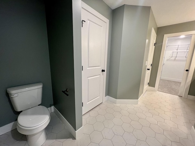 bathroom featuring tile patterned floors and toilet