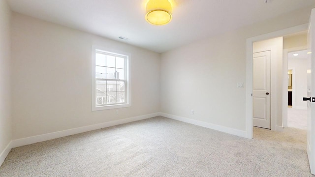 empty room with light colored carpet