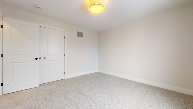 unfurnished bedroom featuring carpet and a closet