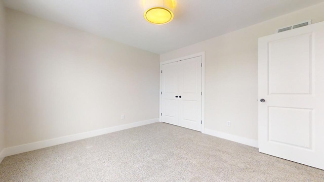 unfurnished bedroom featuring a closet and carpet floors