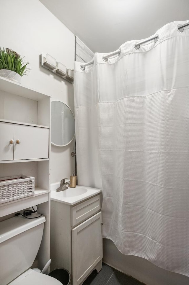 full bath featuring shower / tub combo, toilet, and vanity