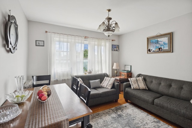 living area featuring an inviting chandelier and wood finished floors