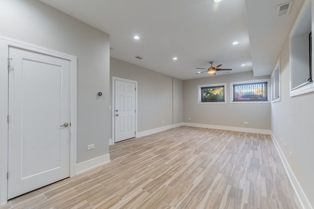 spare room with ceiling fan and light wood-type flooring