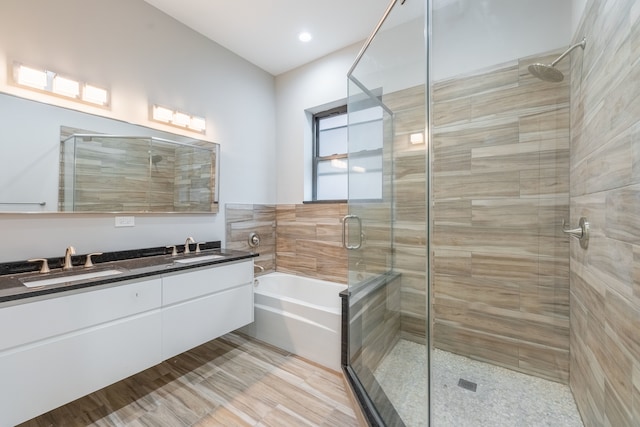 bathroom with double vanity and independent shower and bath