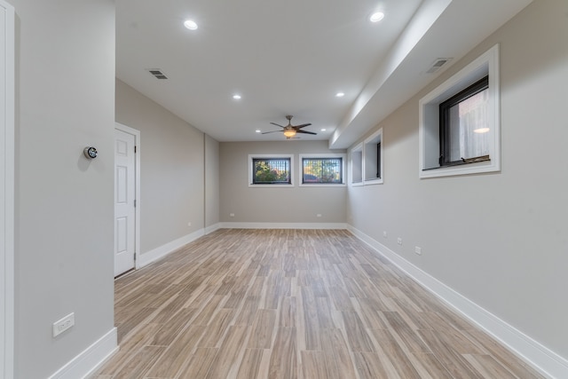 spare room with ceiling fan and light wood-type flooring