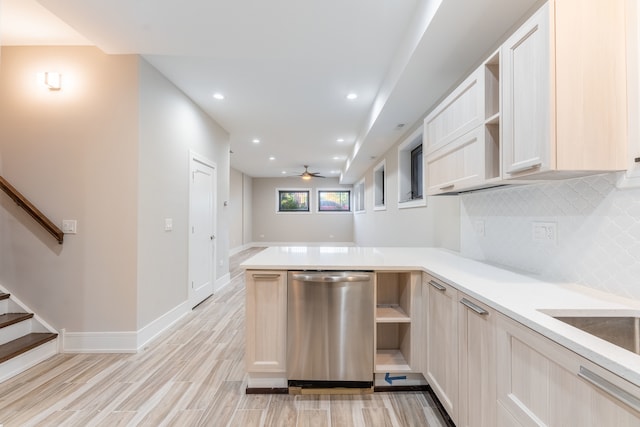 kitchen featuring light brown cabinetry, tasteful backsplash, kitchen peninsula, and light hardwood / wood-style flooring