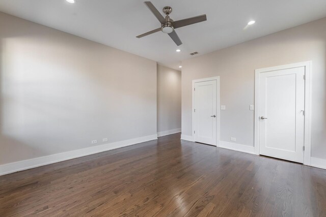 unfurnished room with dark hardwood / wood-style flooring and ceiling fan