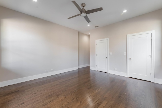 unfurnished bedroom featuring dark wood-type flooring and ceiling fan