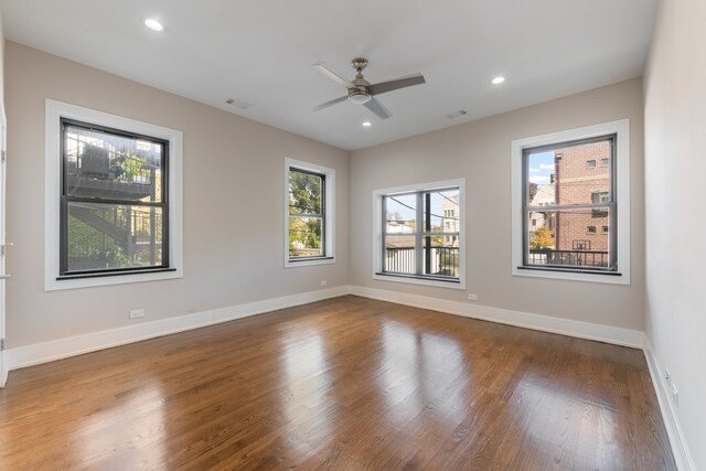 spare room with hardwood / wood-style flooring and ceiling fan