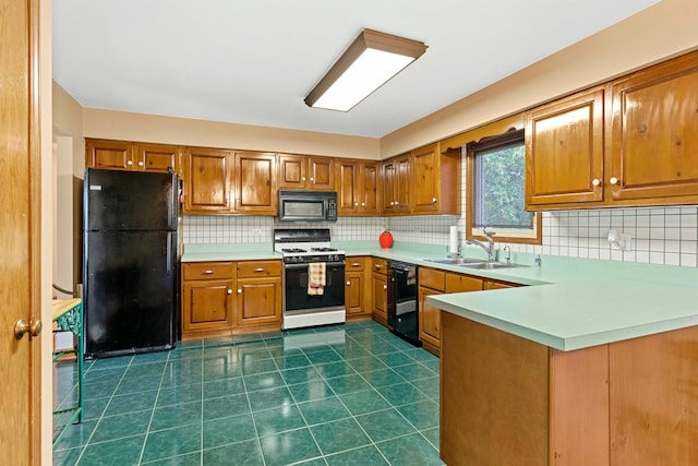 kitchen featuring kitchen peninsula, black appliances, dark tile patterned flooring, decorative backsplash, and sink