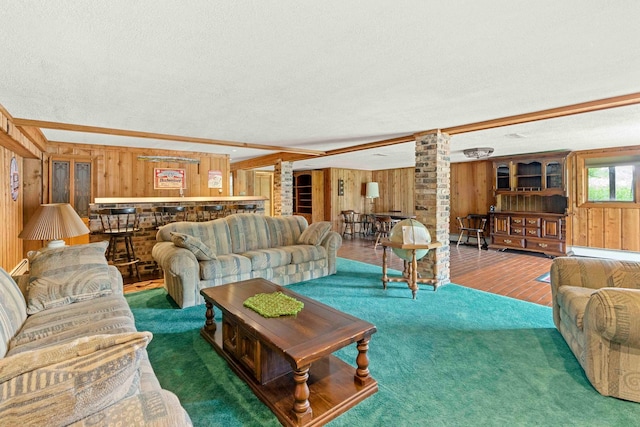 living room featuring brick wall, wood walls, a textured ceiling, and wood-type flooring