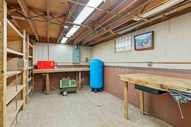 basement with a workshop area and electric panel