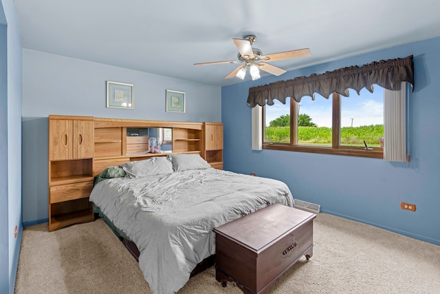 bedroom featuring light colored carpet and ceiling fan