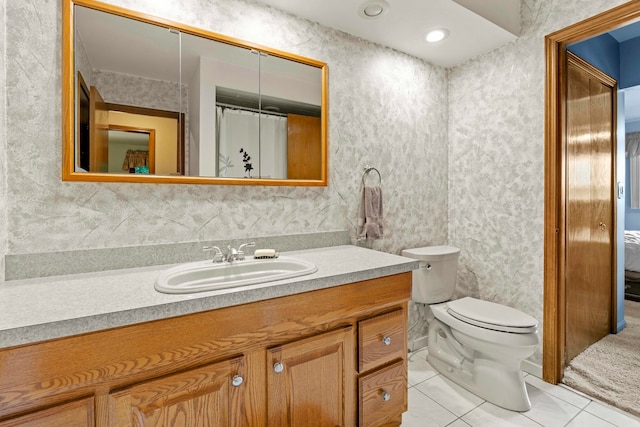 bathroom with vanity, tile patterned floors, and toilet