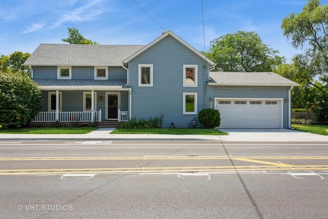 view of front facade with a garage and a porch