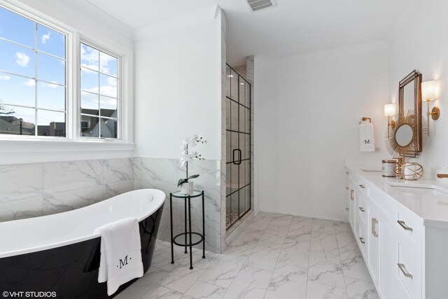 bathroom with shower with separate bathtub, dual bowl vanity, and tile patterned floors