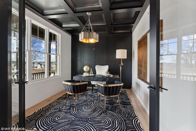 interior space with beam ceiling, coffered ceiling, french doors, and a healthy amount of sunlight